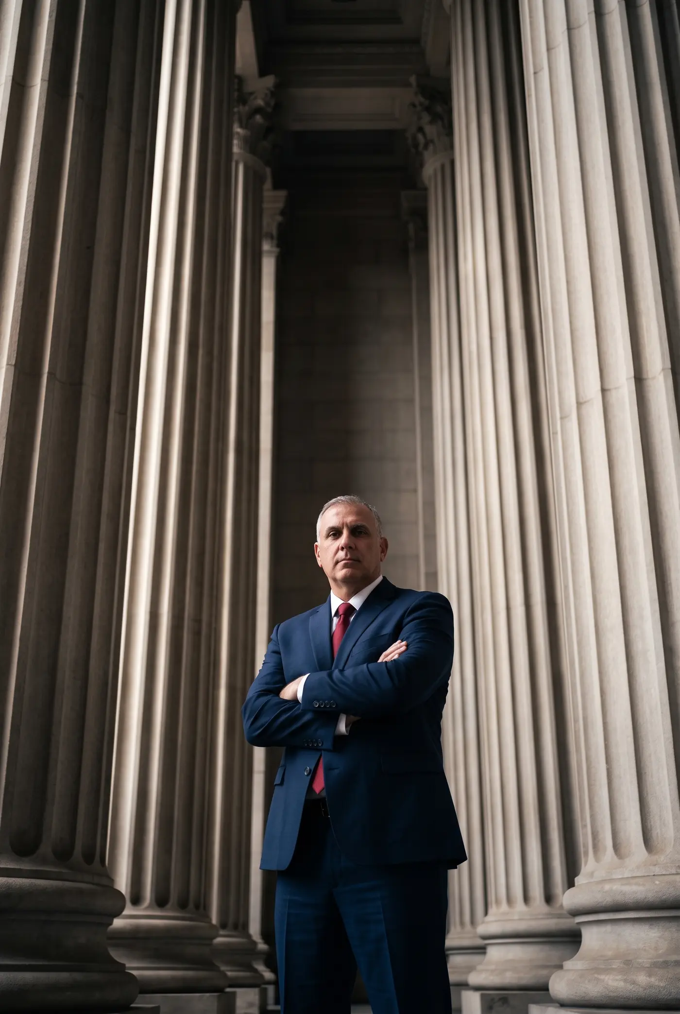 Robert Akouri standing among courthouse columns